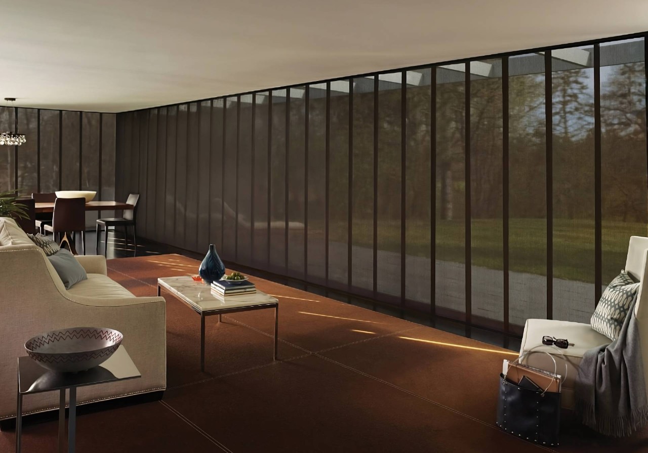 Hunter Douglas Skyline® Panel-Track Blinds on large windows in a cozy living room area at PSI Window Coverings near Scottsdale, AZ