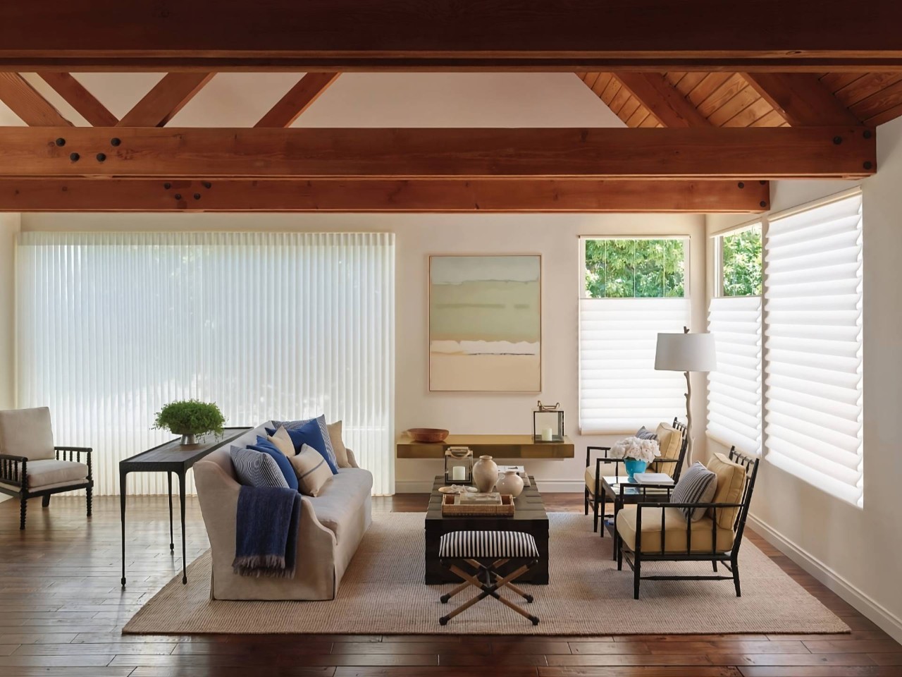 Spacious and luxurious living room with window shades, featuring Vignette® Modern Roman Shades at PSI Window Coverings near Scottsdale, AZ
